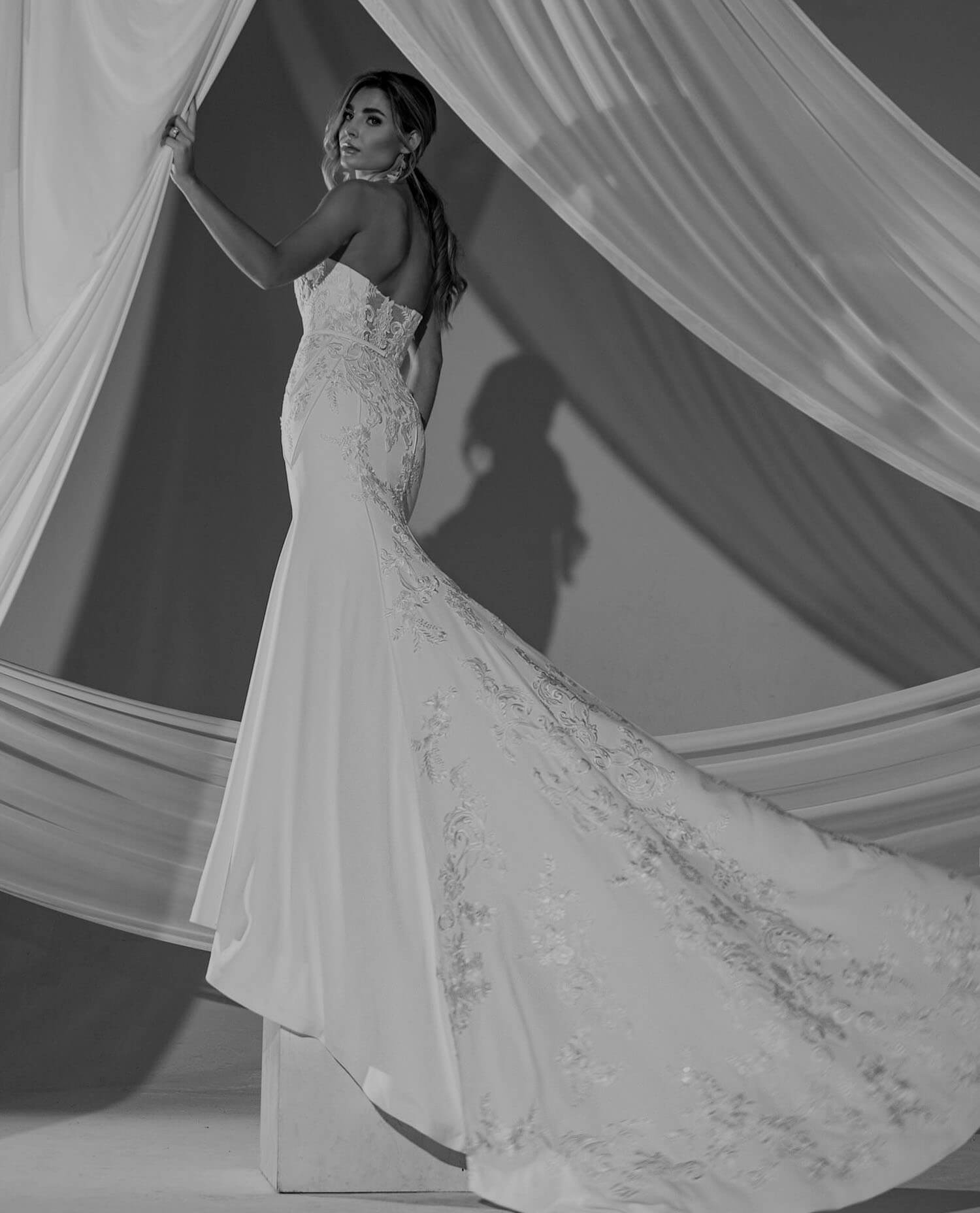 Model wearing a white gown. Mobile image
