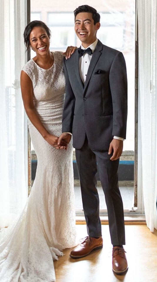 Сouple wearing a white gown and a black suit